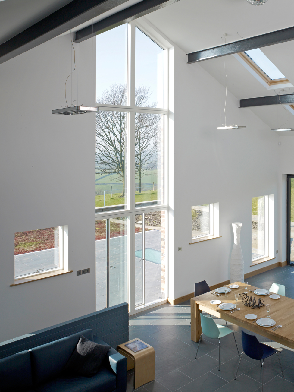 A double-height window is used to draw attention to the stunning view of the Cheshire Plain. The space faces north and is flooded with natural light, without the worry of glare or overheating from direct sun.